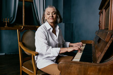 Elderly Woman Sitting On A Chair Near The Piano Music Performance