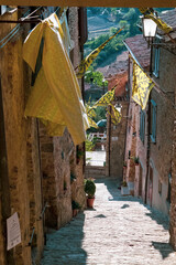 View of a characteristic street in the town of San Casciano dei Bagni. Note the beautiful medieval flags.