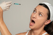 © vladimirfloyd - Portrait of a young scared woman on a face filler injection procedure