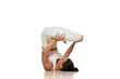 © vladimirfloyd - Yoga, sport, training and lifestyle concept - Young woman in white sportswear doing yoga practice.