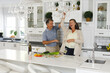 © WavebreakMediaMicro - Happy senior caucasian couple in modern kitchen, dancing together and smiling