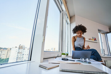 Attractive young female architect working from home