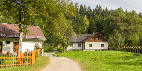 Wall Mural - Panorama of a walking path and traditional houses in the Sumava mountains, Czech Republic