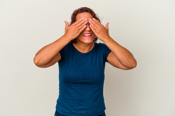 Middle age latin woman isolated on white background afraid covering eyes with hands.