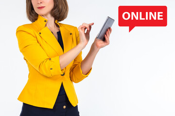 Online business, trading or learning. A woman with a tablet next to the word Online. Space for the text. Work and study on the Internet. A girl with an electronic gadget is isolated on white.