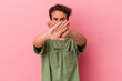 Young caucasian man isolated on pink background doing a denial gesture