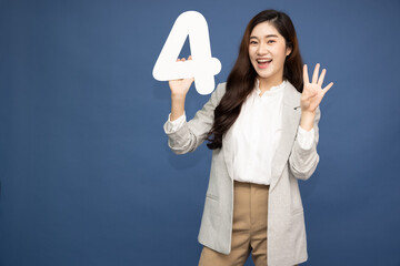 Wall Mural - Young Asian business woman showing number 4 or four isolated on deep blue background