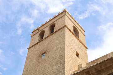 Sticker - Low-angle closeup of the brown stone tower with bells.