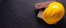 Construction Hardhat With Brick On Black Background. Helmet And Bricks