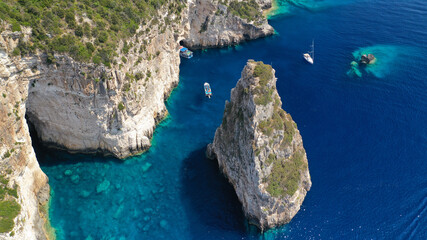 Wall Mural - Aerial drone photo of iconic Ortholithos and azure caves with deep turquoise sea where submarine Papanikolis was hiding during world war II, Paxos island, Ionian, Greece