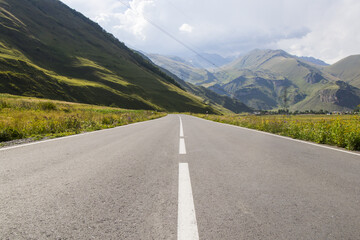 Poster - Scenic view of an asphalt road on a mountainous background in Juta, Georgia