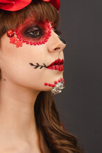 Detail Portrait Of A Beautiful Young Girl With Dia De Los Muertos Makeup With Gray Background.