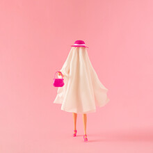 Girl In Ghost Costume With Pink Hat, Purse And High Heels. Minimal Fashion Pink Halloween Party Concept.