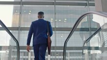 Young African American Businessman On Escalator Successful Male Executive Arriving In Corporate Office Building Looking Out Window Planning Ahead 4k