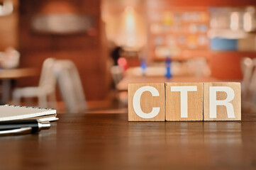 Poster - On a wood board, wooden word cubes are arranged in the letters CTR. It is an abbreviation for Click Through Rate.