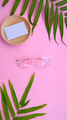 Wall Mural - round glasses in the photo in minimal summer style on a pastel pink color background.