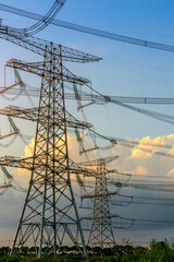 High voltage power tower industrial landscape at sunrise,urban power transmission lines.