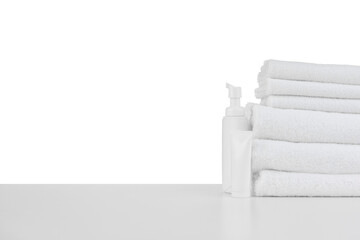 Wall Mural - Composition of cosmetic bottles and towels isolated on white