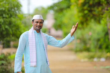 Young indian farmer in traditional wear and giving expression.