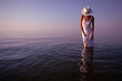 Elegant woman on water. Sunset and beautiful stranger