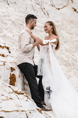 Wall Mural - Beautiful wedding couple bride and groom at wedding day outdoors at ocean beach. Happy marriage couple o