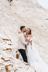 Wall Mural - Beautiful wedding couple bride and groom at wedding day outdoors at ocean beach. Happy marriage couple o