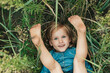 © Serenkonata - happy little girl in jeans blue dress lies in field of wildflowers
