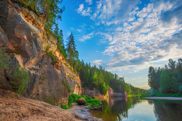 Peaceful landscape with Gauja river and red sandstone Erglu kliffs steep rocks in Gauja National Park in Valmiera area