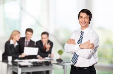 Poster - Handsome young business man standing confident in the office in front of business team