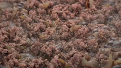 Wall Mural - Fry minced  meat in pan, close up. Meat cooking concept. 4K UHD video