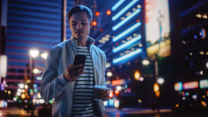 Sticker - Portrait of Man Using Smartphone, Drinking Beverage, Walking Through Night City Street Full of Neon Light. Smiling Stylish Man Using Mobile Phone, Social Media, Online Shopping, Texting on Dating App