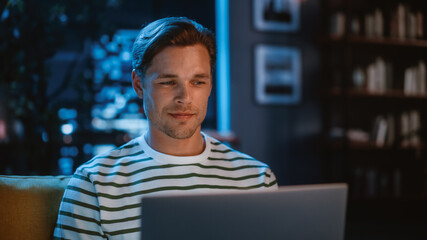 Poster - Man Using Laptop at Home Office, Does Remote Work in the Evening. Handsome Male Sitting on Sofa Works On Computer, Brainstorms Creative Project, does Online Shopping, Browsing Internet. Close-up Shot