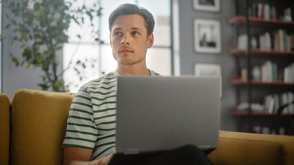 Aufkleber - Portrait of a Man Using Laptop at Home Office, Does Remote Work. Male Sitting on Sofa Works On Computer, Brainstorms Project, does Online Shopping, Browsing Internet, Day Job.