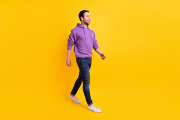 Wall Mural - Full body profile side photo of young handsome man happy positive smile go walk isolated over yellow color background