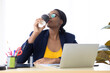 © NVB Stocker - Portrait Attractive young african american businesswoman drinking black coffee in modern home office.