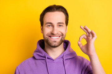 Wall Mural - Photo of young man happy positive smile show okay alright advice choice sign isolated over yellow color background