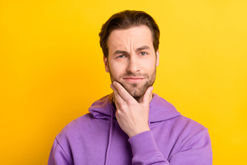 Poster - Photo of serious clever guy hand chin think look camera wear violet hoodie isolated yellow color background