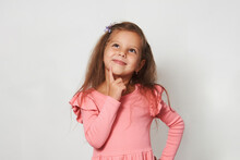 Portrait Of Cute Thoughtful Child Girl Against White Background