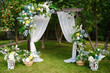 Wedding arch at the exit registration on the green alley, floral decor