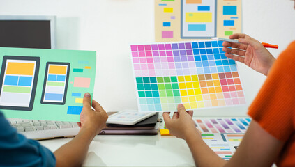 Mobile programmer working at office desk. Mobile application color layout design.