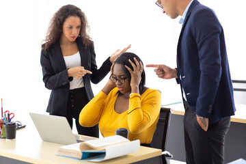 African American business woman upset serious mistake and bad work. Man and woman colleagues bullying and blaming female associate pointing fingers at her