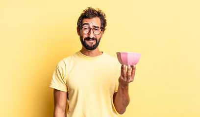 Wall Mural - expressive crazy man feeling sad and whiney with an unhappy look and crying and holding a pot