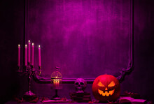 Scary Laughing Pumpkin And Old Skull On Ancient Gothic Fireplace. Halloween, Witchcraft And Magic.