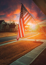 American Flag Outside Residential Home At Dawn