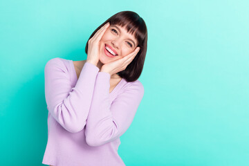 Canvas Print - Photo portrait woman with bob hair touching cheeks overjoyed happy isolated vibrant teal color background