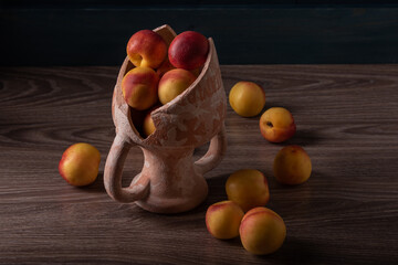 Wall Mural - Smooth peaches or nectarines in a broken amphora.