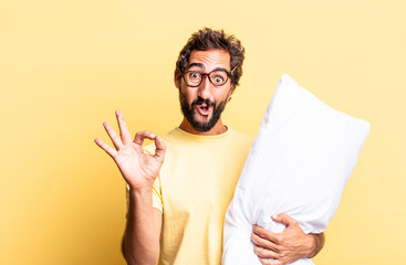 Wall Mural - expressive crazy man feeling happy, showing approval with okay gesture and holding a pillow