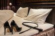 © kesuku - ベッドに置かれた鞭とハイヒール　SMプレイのイメージ　whip and high heels on the bed