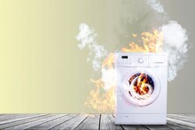 Broken White Washing Machine With Smoke And Fire