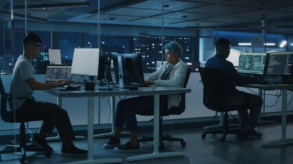 Poster - Diverse Office at Night: Multi-Ethnic Team of Young Programmers Working on Computers, Screens Show Coding Language User Interface. Software Engineers Create Innovative e-Commerce App. Wide Dolly